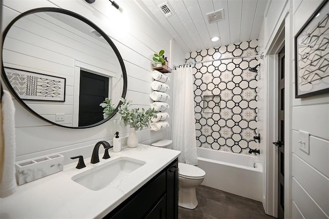 full bathroom with tile patterned floors, vanity, toilet, and shower / bath combo with shower curtain