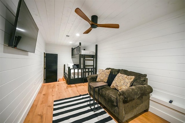 living room featuring ceiling fan, wood ceiling, and hardwood / wood-style flooring