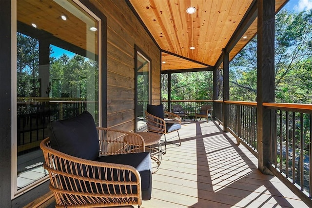 sunroom featuring a wealth of natural light, wood ceiling, and vaulted ceiling