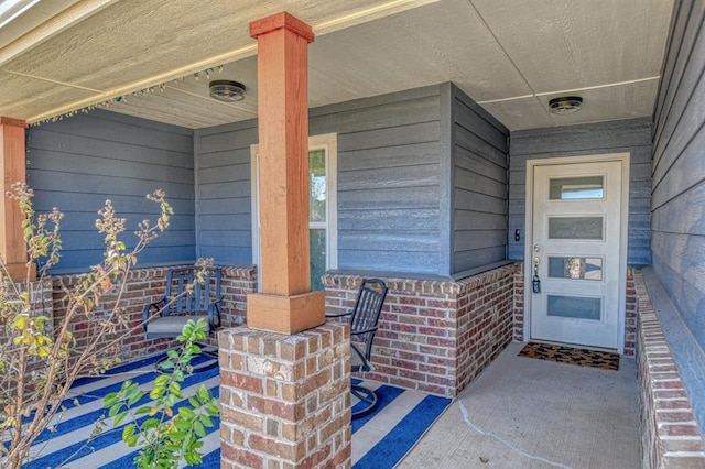 view of exterior entry featuring a porch