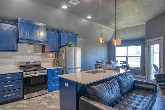 kitchen with pendant lighting, stainless steel appliances, light countertops, a kitchen island with sink, and premium range hood