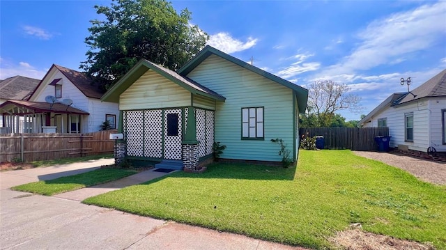 bungalow-style home with a front lawn