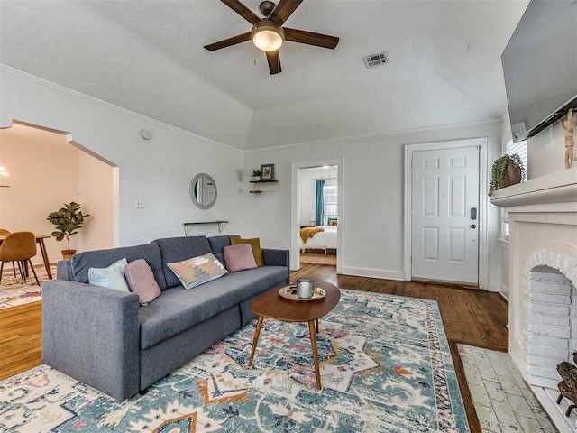 living room with a wealth of natural light, light hardwood / wood-style floors, and lofted ceiling