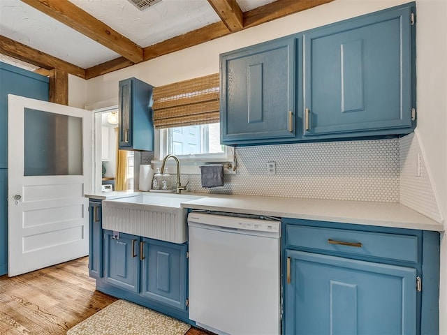 kitchen featuring white dishwasher, sink, light wood-type flooring, and blue cabinetry