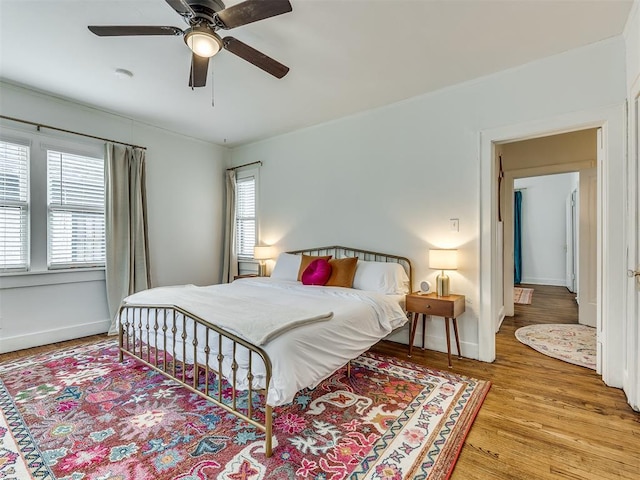 bedroom with ceiling fan and light hardwood / wood-style flooring