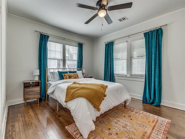 bedroom with ceiling fan, dark hardwood / wood-style flooring, and crown molding