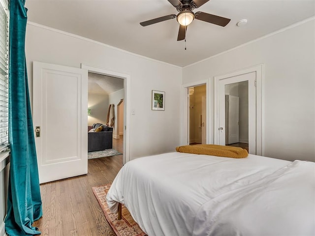 bedroom with hardwood / wood-style floors, ceiling fan, and ornamental molding