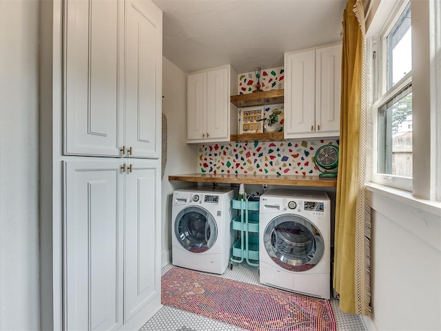 laundry area featuring cabinets and separate washer and dryer