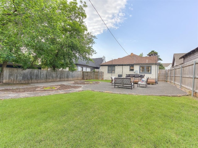 view of yard with an outdoor living space and a patio area