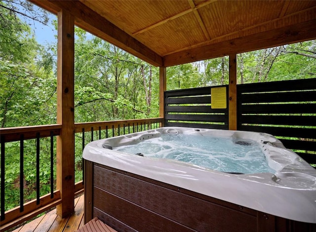 wooden deck with a hot tub