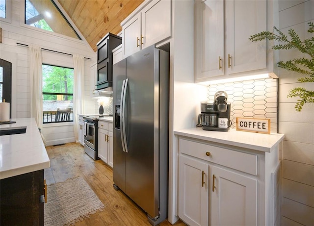 kitchen featuring wooden ceiling, white cabinets, stainless steel appliances, and vaulted ceiling