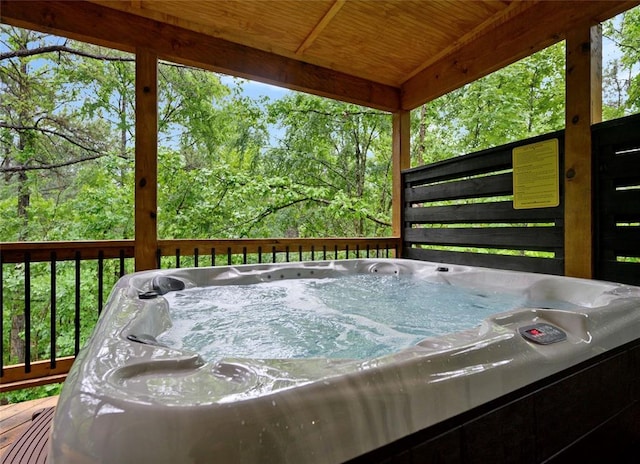 wooden deck featuring a hot tub