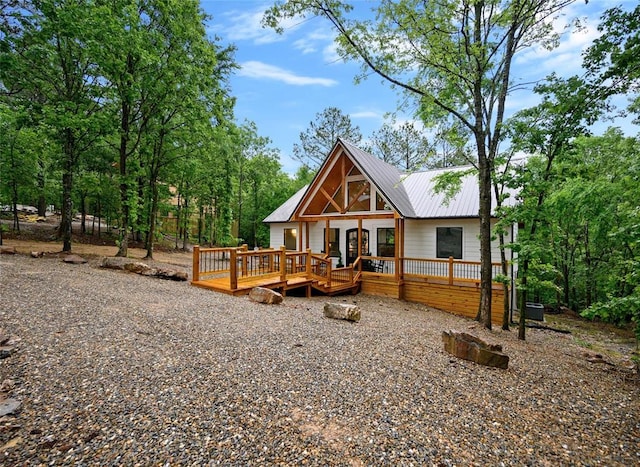 rear view of property featuring central air condition unit and a deck