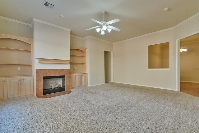 unfurnished living room featuring ceiling fan, a fireplace, light colored carpet, and ornamental molding