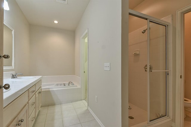 bathroom with vanity, tile patterned flooring, and plus walk in shower