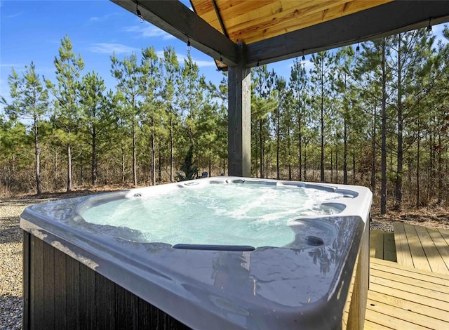 view of swimming pool featuring a hot tub and a wooden deck