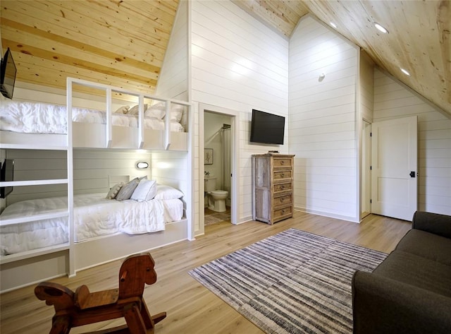 bedroom with ensuite bathroom, high vaulted ceiling, wood ceiling, and light wood-type flooring