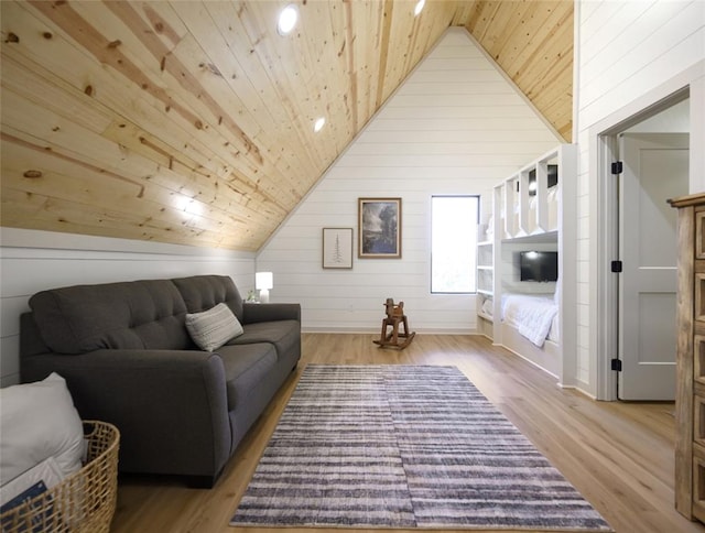 living room featuring wooden walls, high vaulted ceiling, light wood-type flooring, and wood ceiling