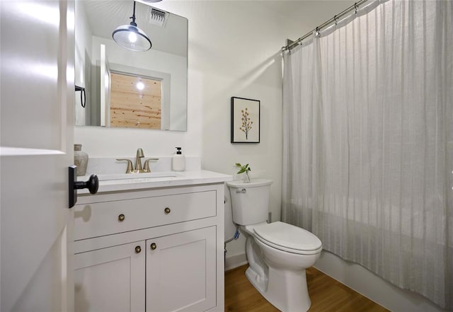 full bathroom featuring shower / bath combination with curtain, vanity, wood-type flooring, and toilet