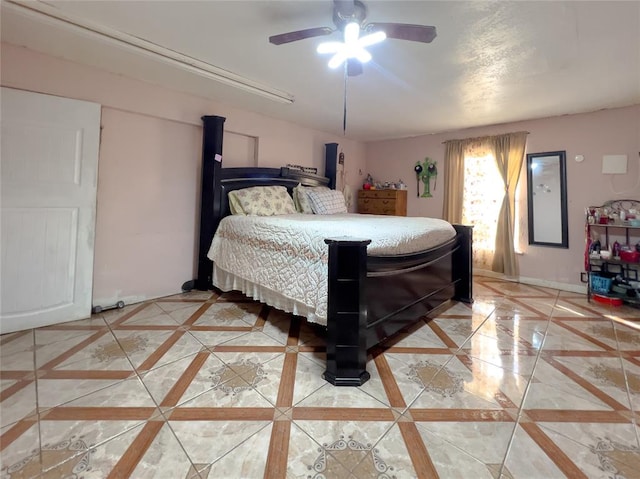 tiled bedroom featuring ceiling fan