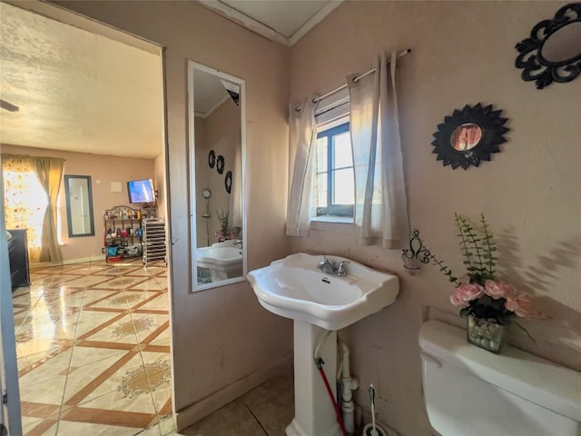 bathroom featuring tile patterned flooring, sink, toilet, and crown molding