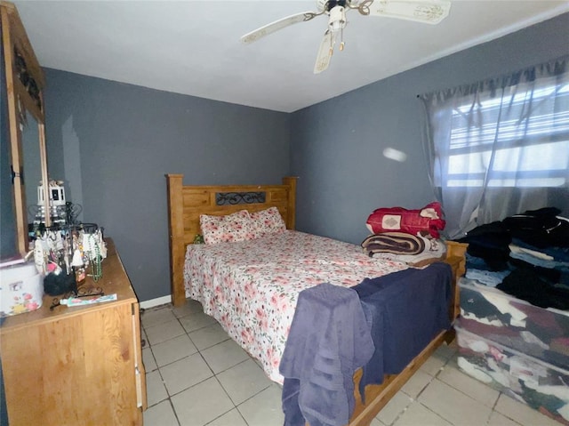 tiled bedroom featuring ceiling fan