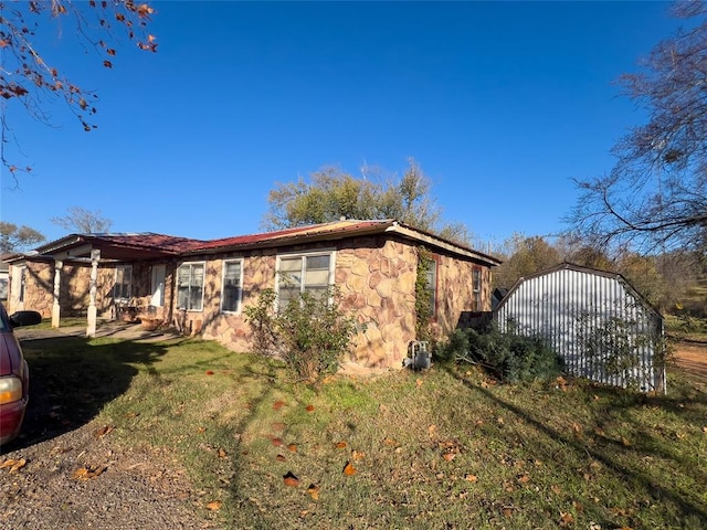 view of front of property with a shed and a front lawn