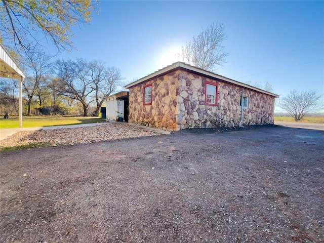 520 S Main St, Lexington, OK 73051 - view of side of property featuring stone siding