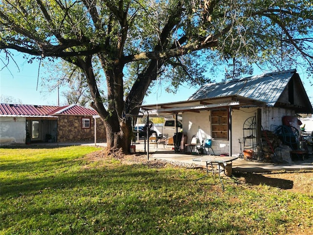 520 S Main St, Lexington, OK 73051 - back of house featuring a yard, a metal roof, and concrete block siding