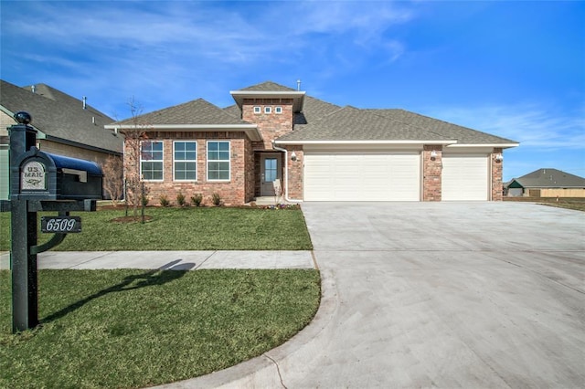 prairie-style home with a garage and a front lawn