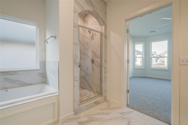 bathroom with separate shower and tub