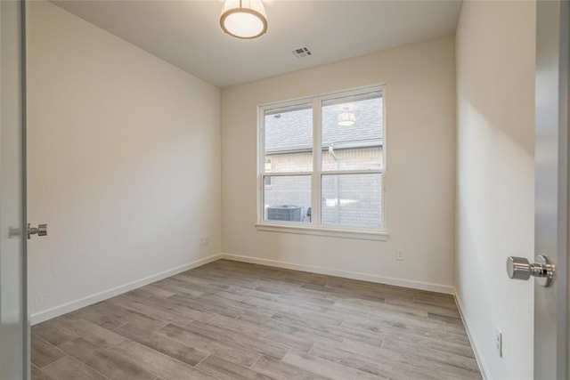 spare room with light hardwood / wood-style flooring