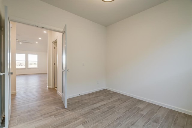 spare room featuring light hardwood / wood-style floors and ceiling fan