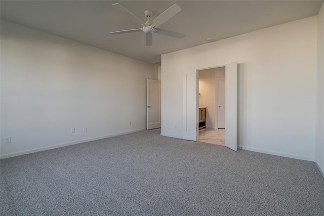 spare room with ceiling fan and light colored carpet