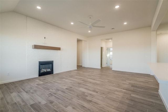 unfurnished living room featuring ceiling fan, hardwood / wood-style floors, and lofted ceiling