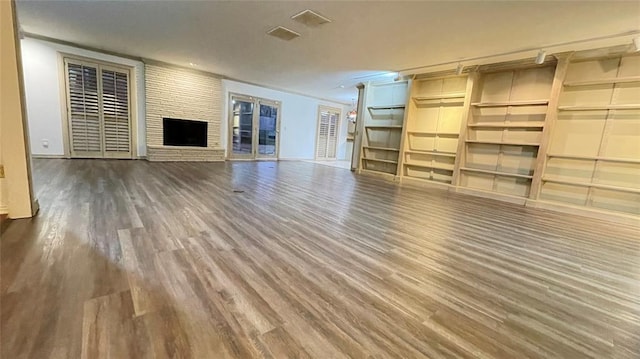 unfurnished living room featuring a fireplace and hardwood / wood-style floors