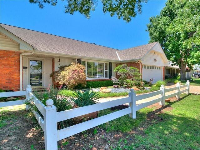 single story home with brick siding, an attached garage, and fence