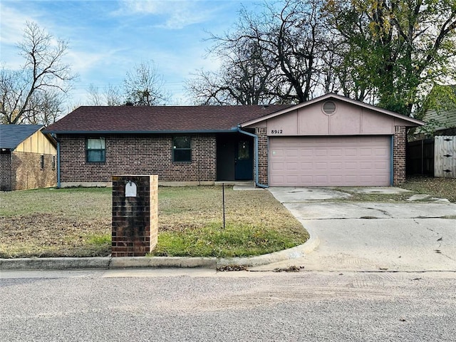 ranch-style home featuring a garage and a front lawn