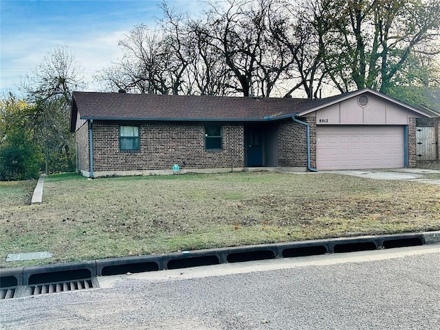 single story home with a front yard and a garage