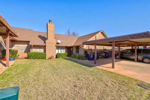 exterior space featuring a carport and a front lawn