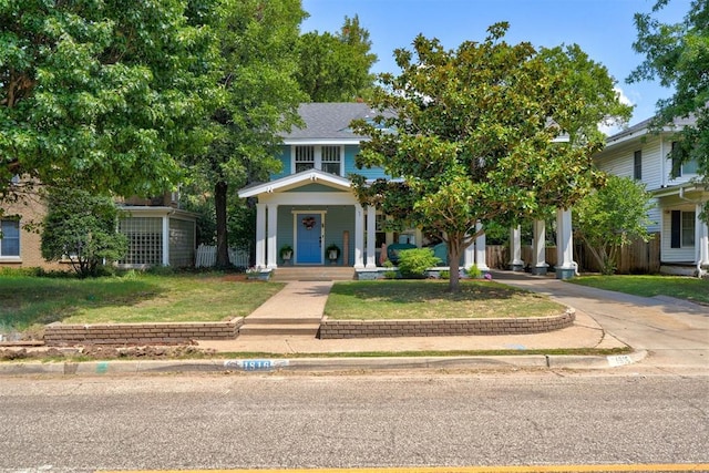 obstructed view of property with a front yard