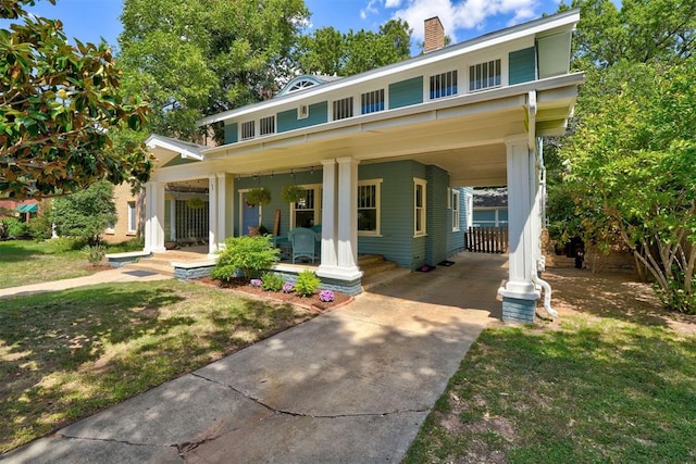 view of front of house featuring a front lawn and a carport