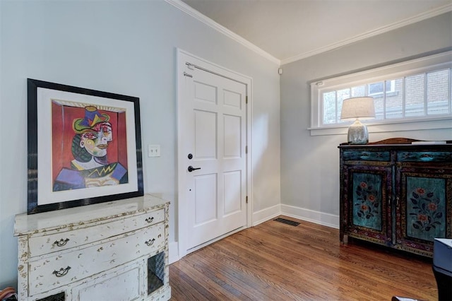 entrance foyer with wood-type flooring and ornamental molding