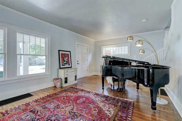 misc room featuring hardwood / wood-style flooring and crown molding