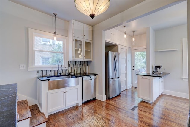 kitchen with white cabinetry and appliances with stainless steel finishes