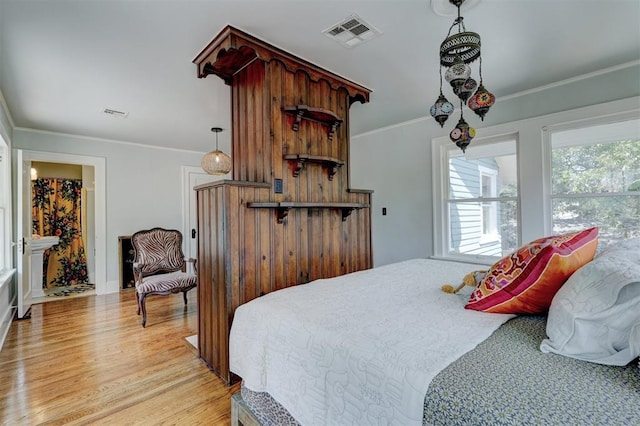 bedroom featuring light hardwood / wood-style flooring and crown molding