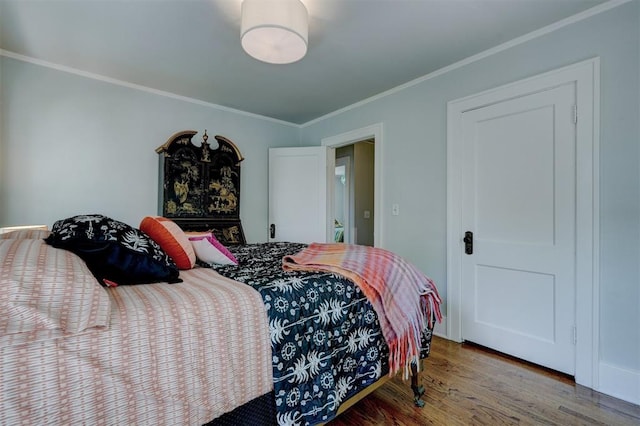 bedroom with hardwood / wood-style floors and crown molding