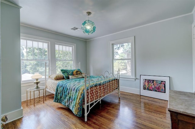 bedroom featuring crown molding and wood-type flooring