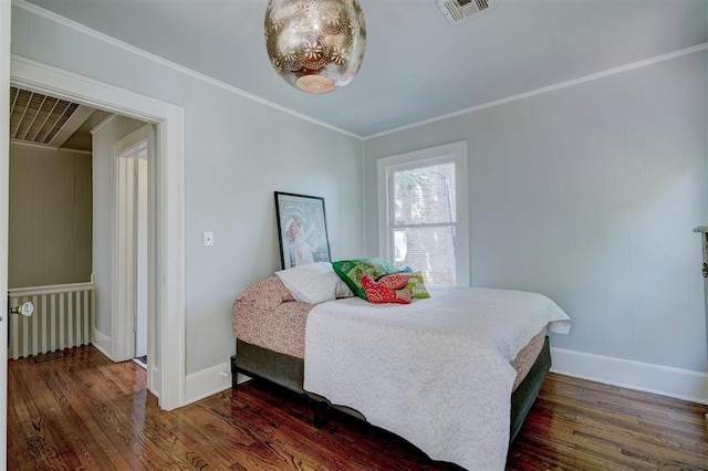 bedroom featuring crown molding and dark wood-type flooring