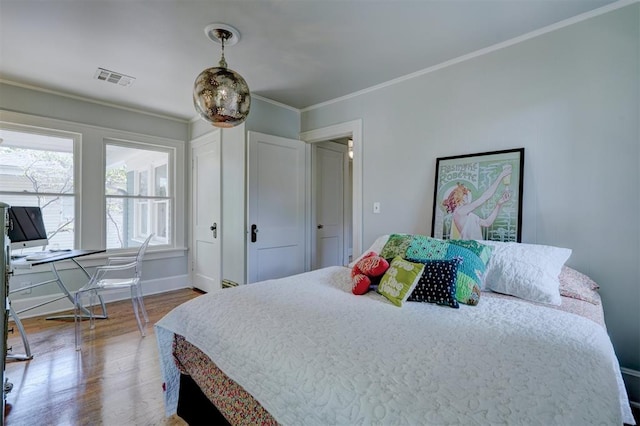 bedroom featuring hardwood / wood-style floors and crown molding